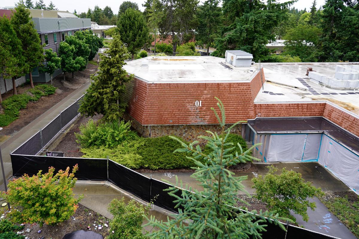 Building 10, fenced off, with the campus walkway, seen from the Building 13 roof deck 